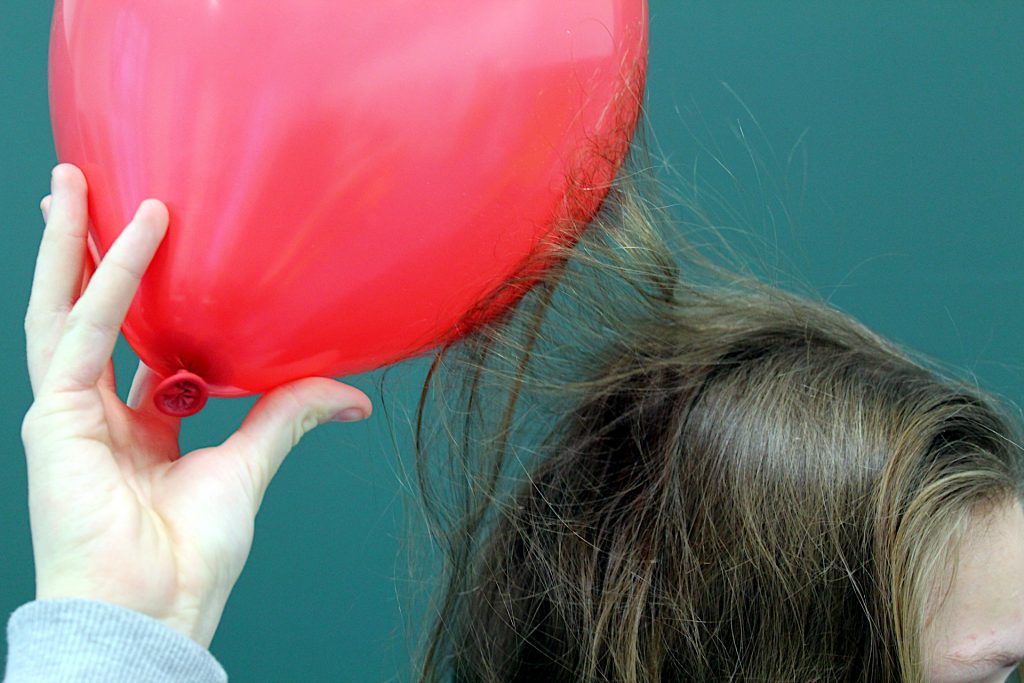 Attractive electric force between hair and balloon